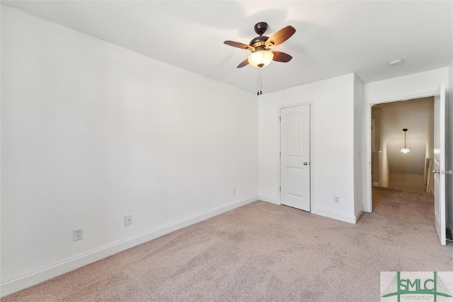 unfurnished bedroom with light carpet and ceiling fan