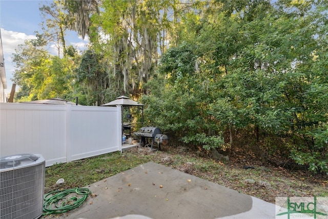 view of yard with central air condition unit and a patio