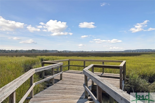 view of dock with a rural view