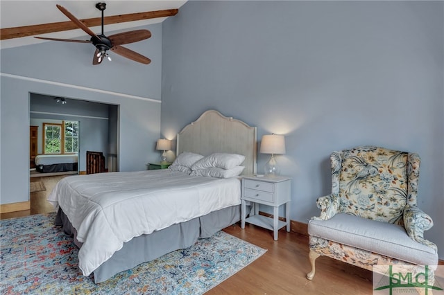 bedroom featuring beam ceiling, high vaulted ceiling, ceiling fan, and wood-type flooring