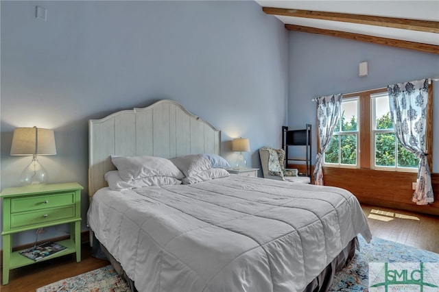 bedroom featuring wood-type flooring, beamed ceiling, and high vaulted ceiling