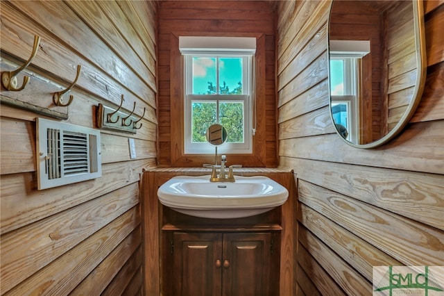 bathroom with wood walls and vanity