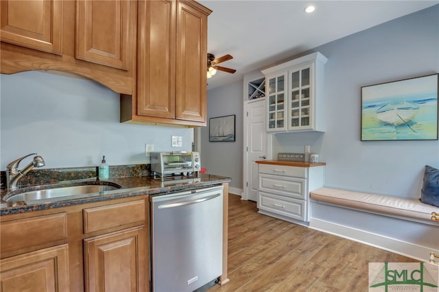 kitchen with ceiling fan, stainless steel dishwasher, sink, white cabinetry, and light hardwood / wood-style flooring