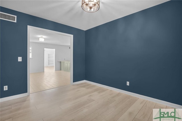 empty room with light hardwood / wood-style flooring