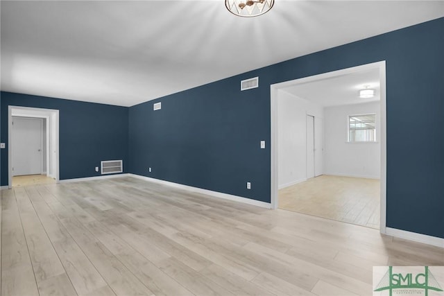 spare room featuring light hardwood / wood-style flooring