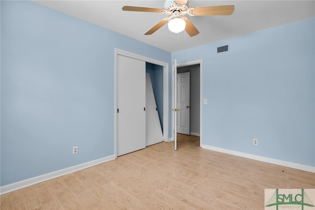 unfurnished bedroom featuring ceiling fan, a closet, and light hardwood / wood-style floors