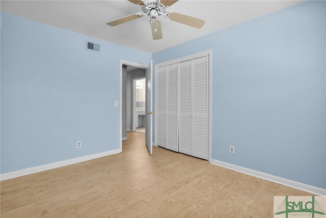 unfurnished bedroom featuring a closet, light hardwood / wood-style flooring, and ceiling fan