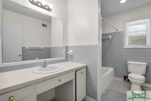 full bathroom featuring shower / bathtub combination, vanity, tile walls, tile patterned flooring, and toilet