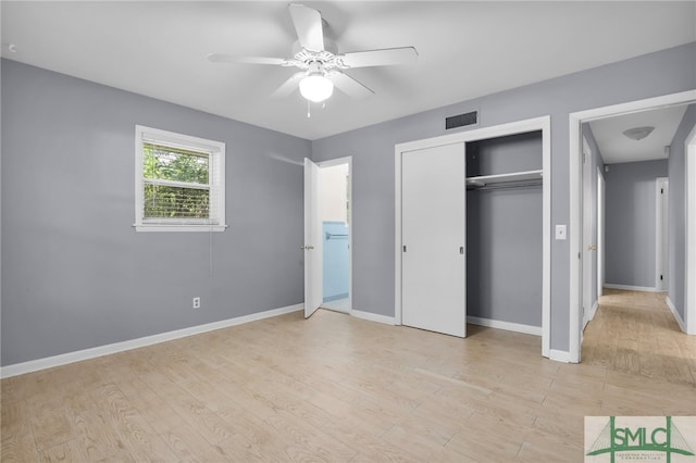 unfurnished bedroom featuring ceiling fan, light wood-type flooring, and a closet