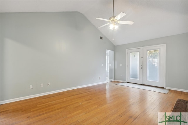 spare room featuring french doors, high vaulted ceiling, light wood-type flooring, and ceiling fan