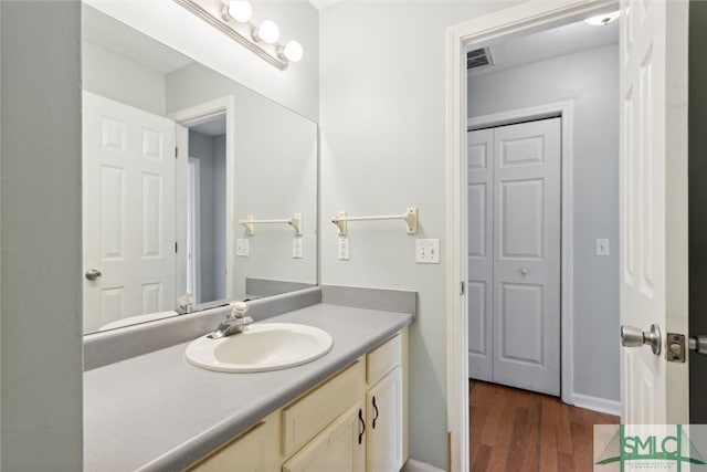 bathroom with vanity and wood-type flooring