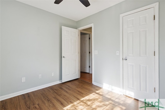 unfurnished bedroom featuring wood-type flooring and ceiling fan