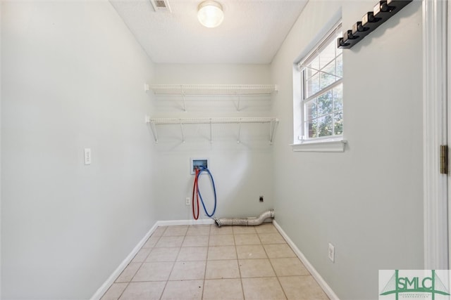 laundry room featuring electric dryer hookup, washer hookup, and light tile patterned floors