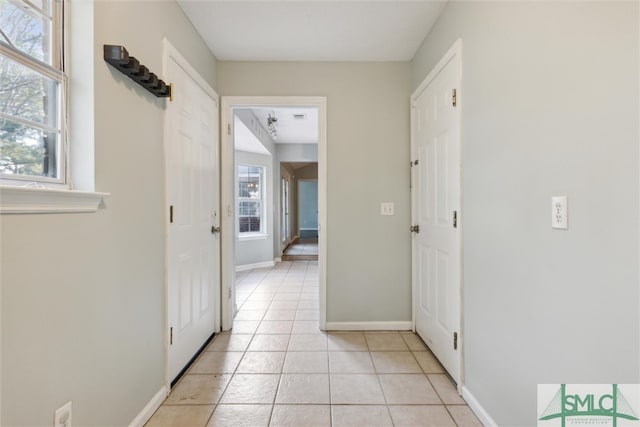 corridor with light tile patterned floors