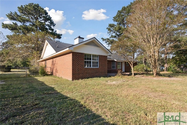 view of home's exterior with a lawn