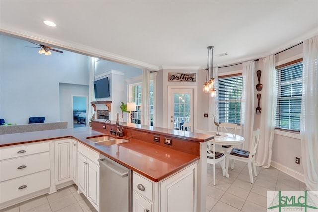 kitchen with pendant lighting, a wealth of natural light, sink, and stainless steel dishwasher