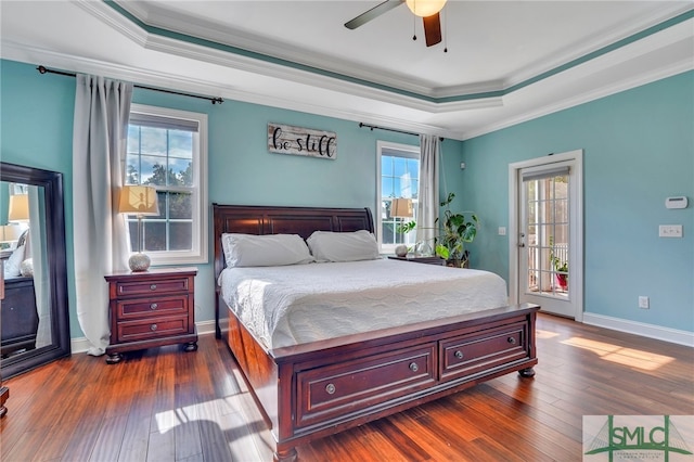 bedroom with crown molding, multiple windows, dark hardwood / wood-style floors, and ceiling fan