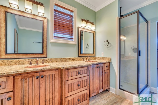 bathroom with a shower with door, vanity, crown molding, and wood-type flooring