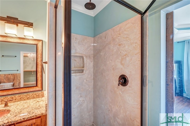 bathroom featuring vanity, ornamental molding, and walk in shower