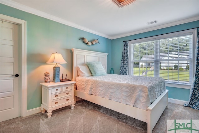 bedroom with ornamental molding and carpet