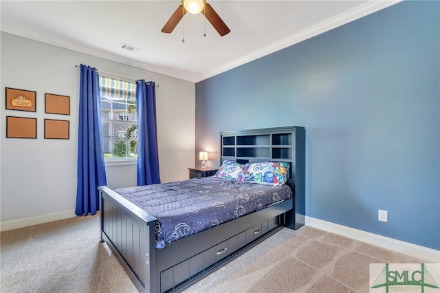 carpeted bedroom featuring crown molding and ceiling fan