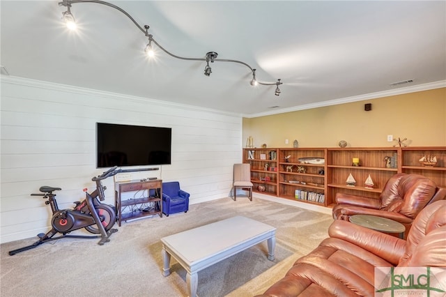 living room with ornamental molding, wooden walls, and carpet flooring