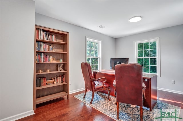 home office with dark hardwood / wood-style flooring