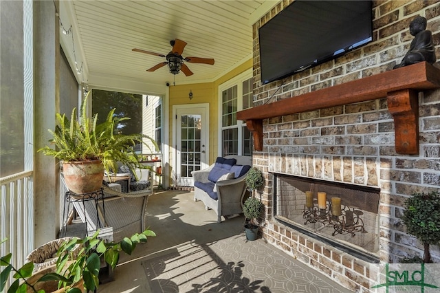 view of patio featuring an outdoor brick fireplace and ceiling fan