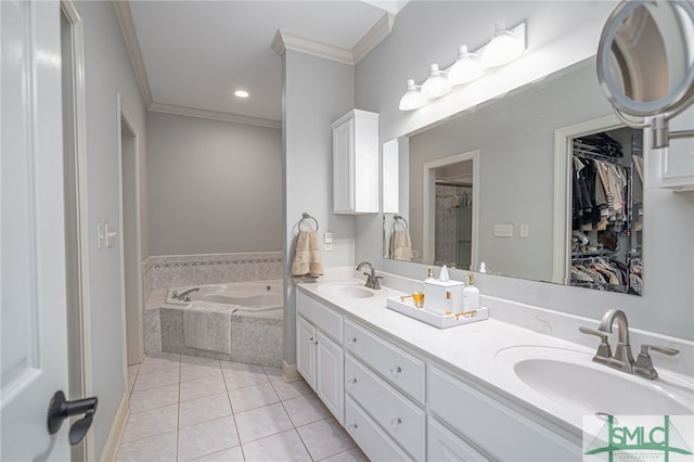 bathroom featuring tile patterned floors, tiled bath, vanity, and ornamental molding