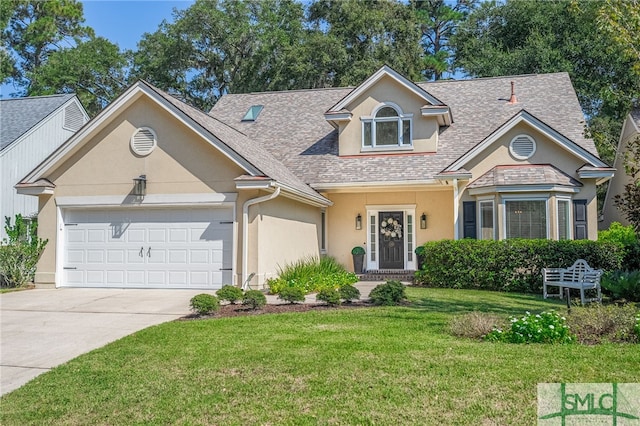 view of front facade with a front yard and a garage