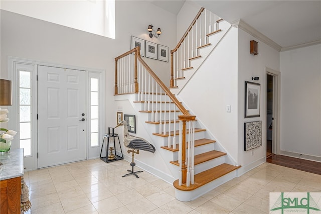 entryway featuring light tile patterned floors and ornamental molding