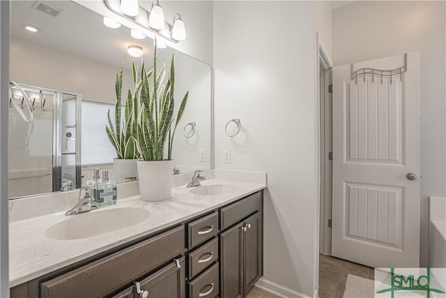 bathroom with vanity and a shower with shower door