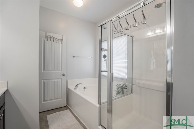 bathroom featuring vanity and shower with separate bathtub