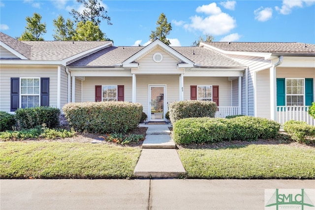 single story home with a front yard and covered porch