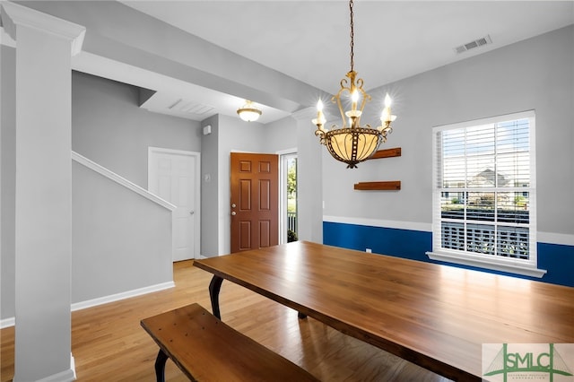 dining space with a notable chandelier and light wood-type flooring