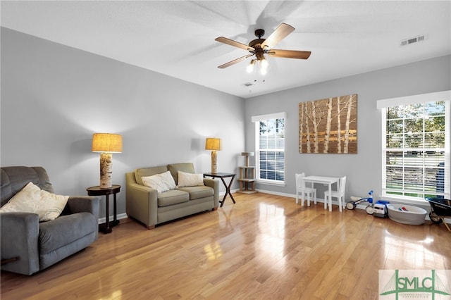 sitting room with light hardwood / wood-style floors and ceiling fan