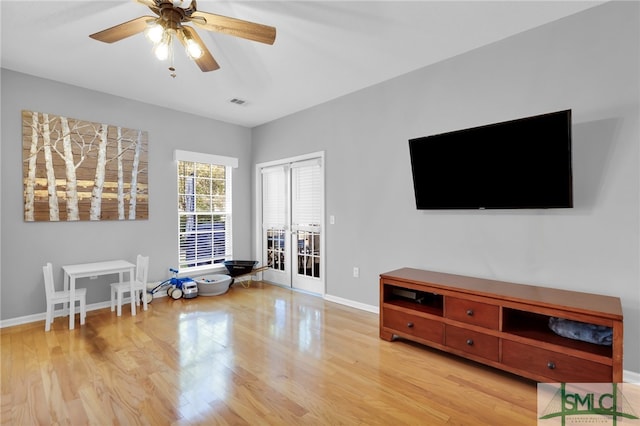 sitting room featuring ceiling fan and light wood-type flooring