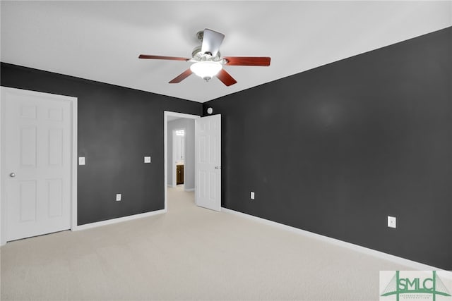 unfurnished bedroom featuring light carpet and ceiling fan