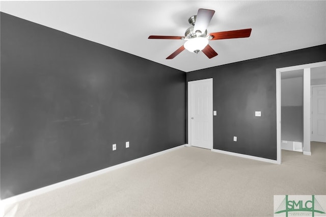 unfurnished bedroom with light carpet and ceiling fan