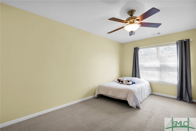 bedroom featuring light colored carpet and ceiling fan