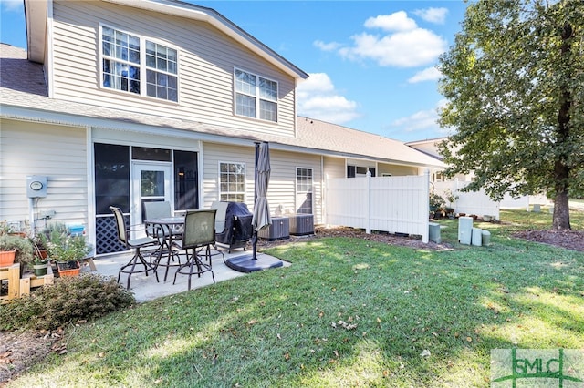 back of house with central air condition unit, a patio area, and a yard