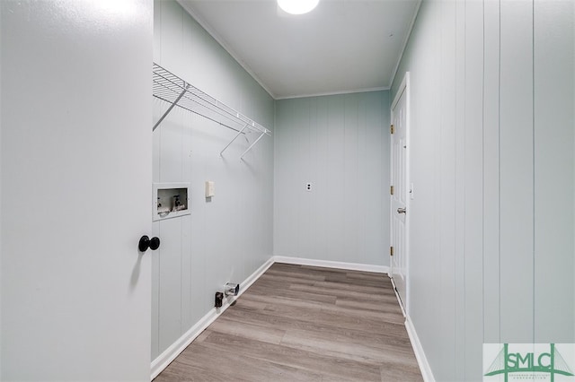 washroom featuring light hardwood / wood-style floors, crown molding, washer hookup, and wood walls