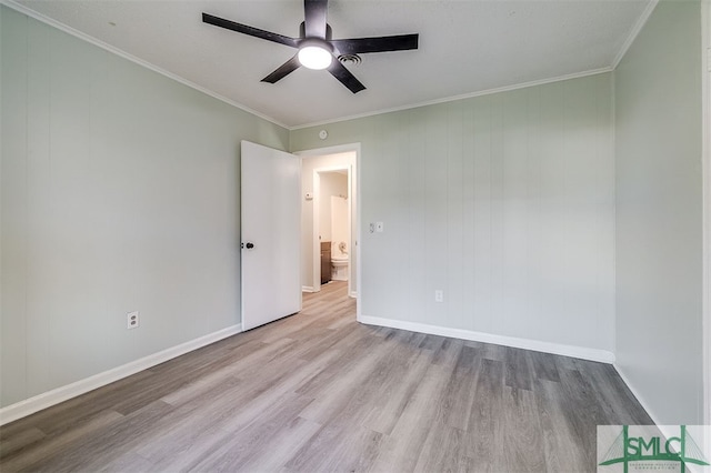 spare room with light hardwood / wood-style floors, crown molding, and ceiling fan