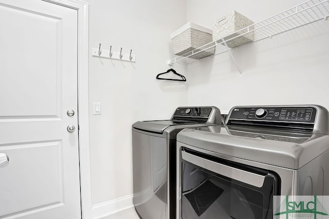 clothes washing area featuring washer and dryer