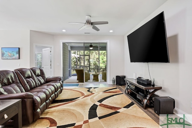 living room featuring light hardwood / wood-style floors and ceiling fan