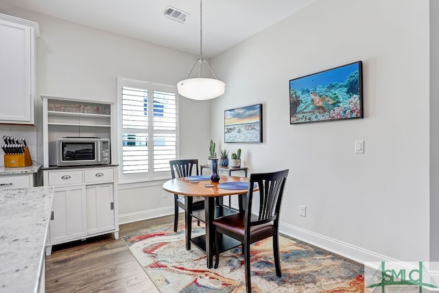 dining space with dark hardwood / wood-style floors