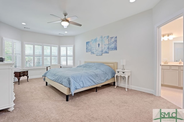 carpeted bedroom featuring sink, connected bathroom, and ceiling fan