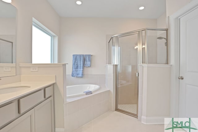 bathroom featuring vanity, tile patterned flooring, and plus walk in shower