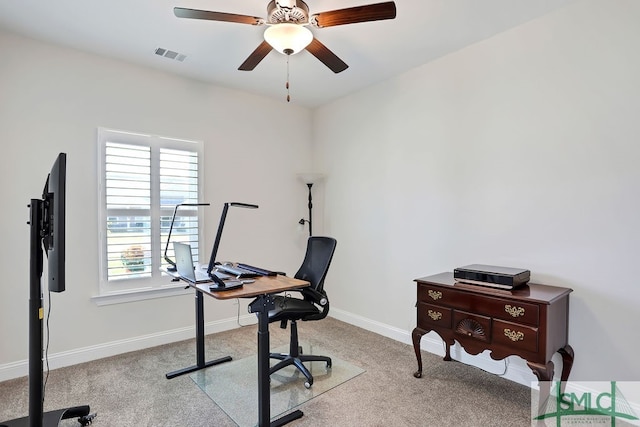 carpeted office space featuring ceiling fan