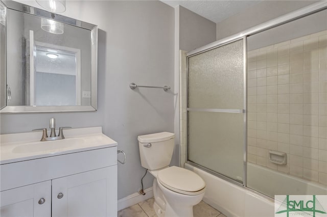 full bathroom featuring toilet, bath / shower combo with glass door, vanity, and tile patterned flooring